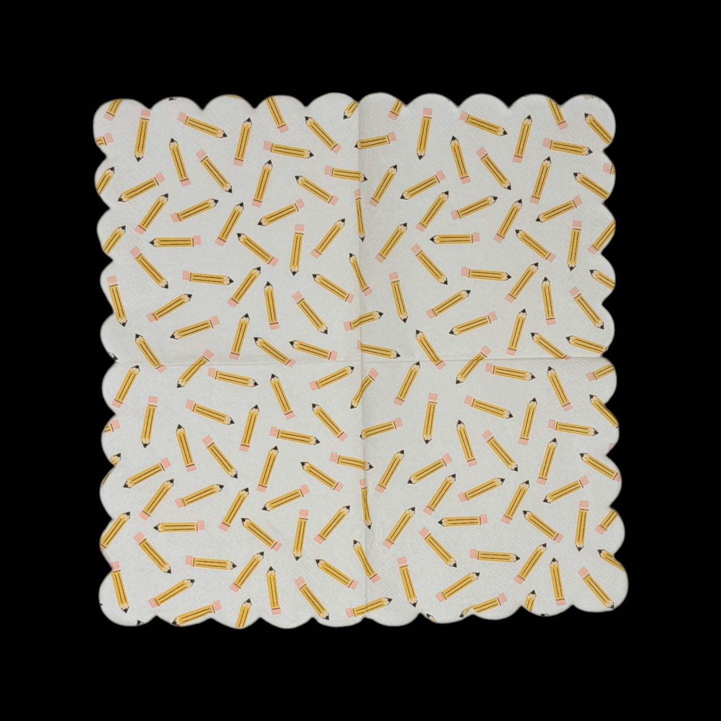 Two cocktail-size decoupage paper napkins featuring an all-over tossed pattern of classic yellow number 2 pencils with pink erasers and sharpened tips scattered in every direction on a crisp white background with a scalloped edge border, photographed on a black surface.