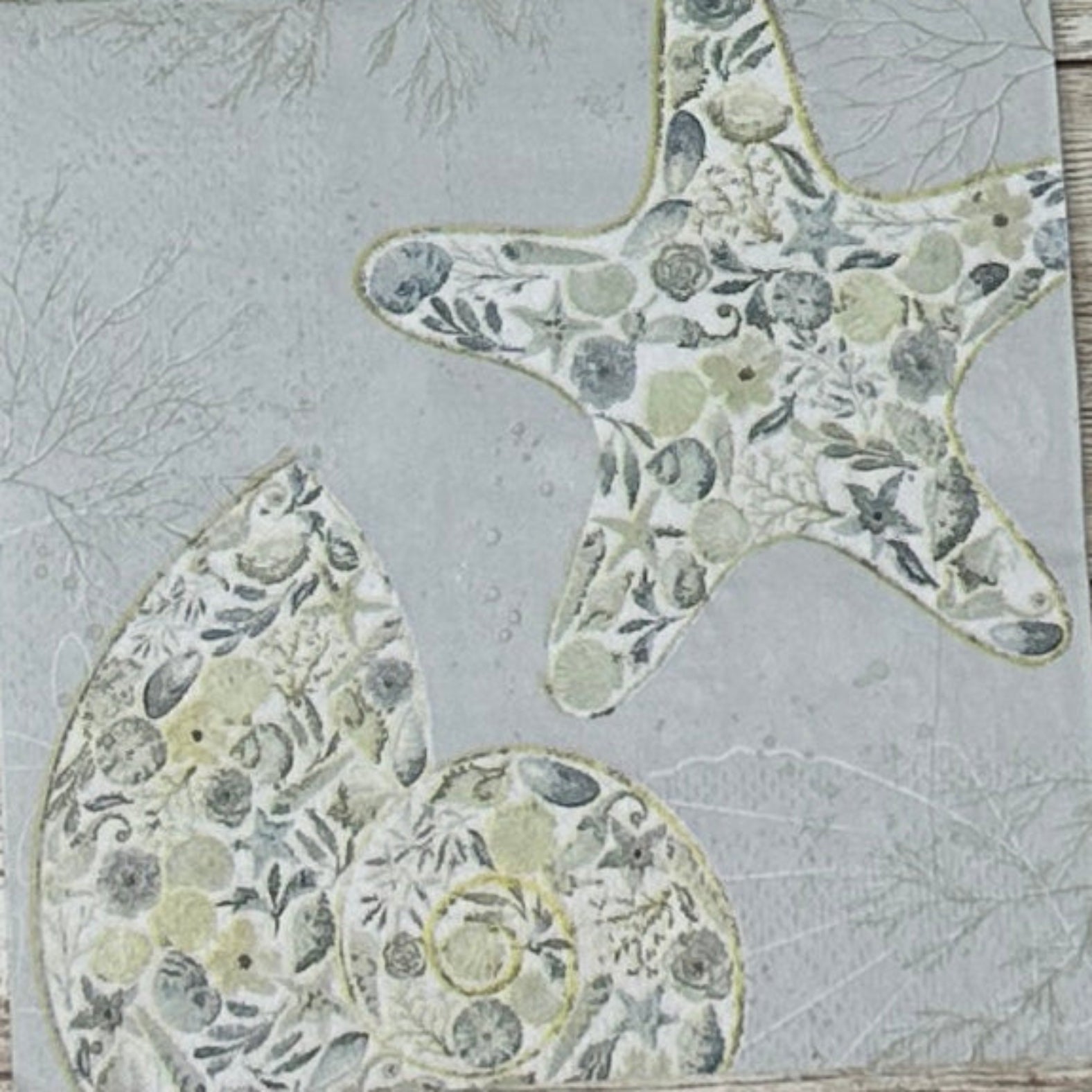 Decorative paper napkin with starfish and shell patterns 