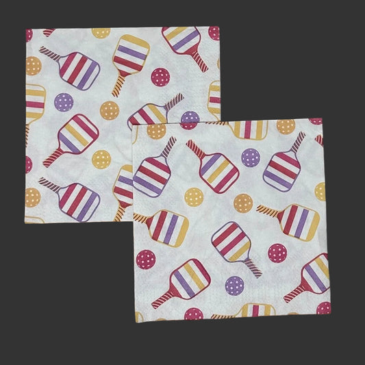 two paper napkins with colorful pickleball paddles