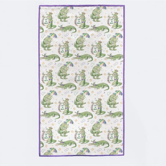 Patterned fabric with green alligator design on a white background