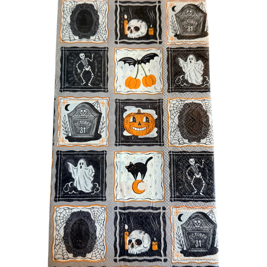 Guest-size decoupage paper napkin featuring a patchwork grid of fifteen individual framed Halloween icons including a skull with candles dancing skeleton friendly ghost grinning pumpkin black cat on crescent moon October 31 tombstone bat cherry and spider webs in black orange and white on a soft grey background