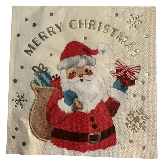 Close-up of a cocktail napkin featuring a retro Santa Claus holding a gift and sack of presents with gold foil “Merry Christmas” text and snowflake accents.
