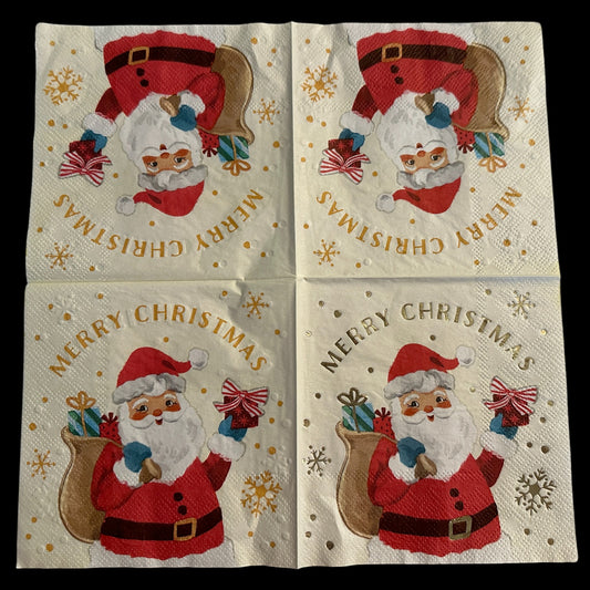 Cocktail-size decoupage paper napkin featuring a retro illustration of a jolly winking Santa Claus in a red suit and blue mittens carrying a gift sack and holding a striped bow present on a soft cream background with gold foil Merry Christmas lettering gold snowflakes and dot confetti accents, photographed on a white surface.