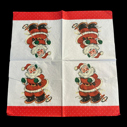 Unfolded Close-up of a cocktail napkin featuring a retro Santa Claus skiing with green mittens and a red suit, set against a white background with a red polka dot  border.