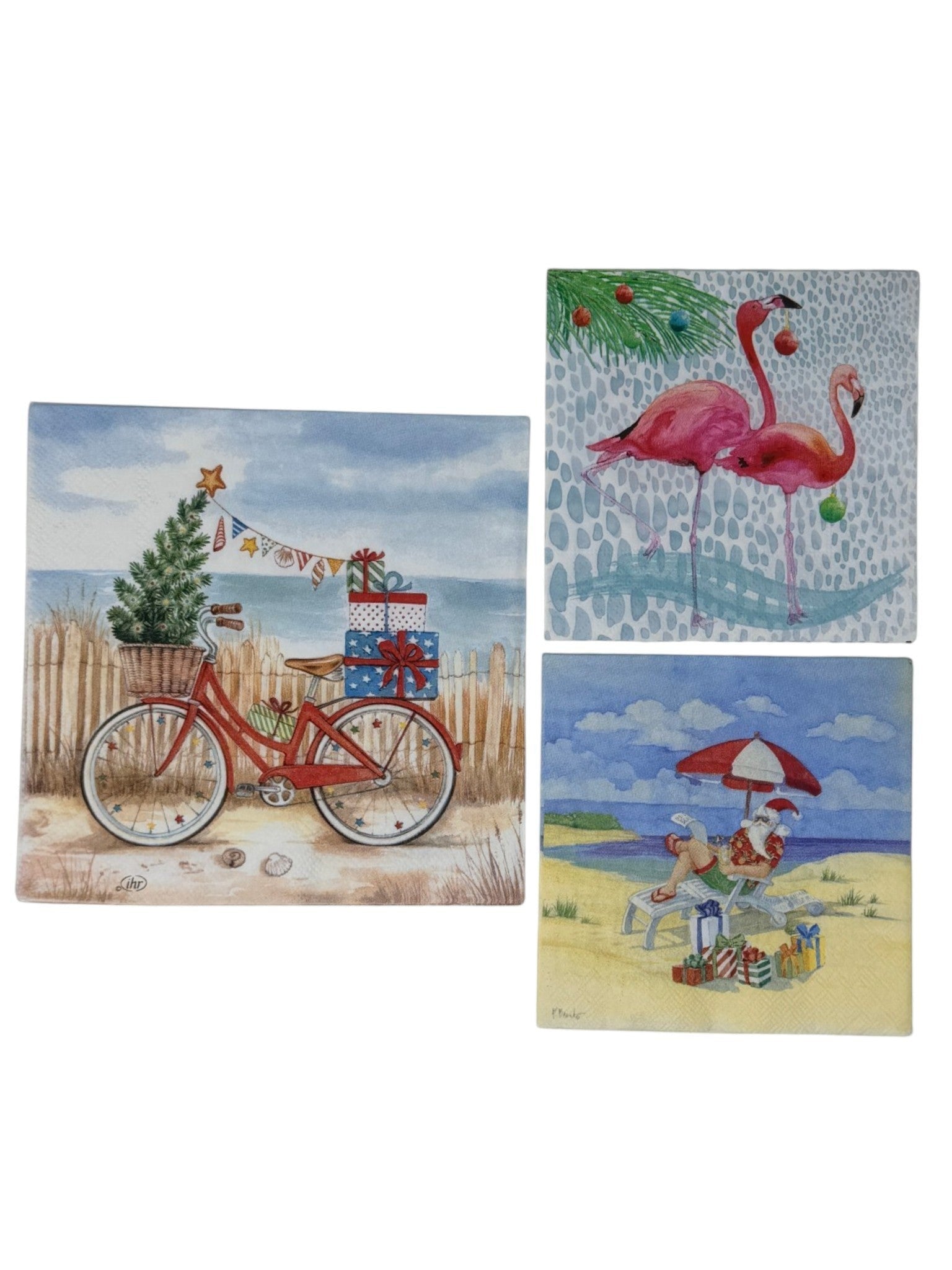 A bundle of six tropical Christmas decoupage paper napkins showing two beach bike Christmas luncheon napkins with a red cruiser bicycle on sandy dunes, two Christmas flamingo cocktail napkins with pink flamingos holding ornaments, and two Beach Santa cocktail napkins with Santa relaxing under a beach umbrella, photographed on a white surface.