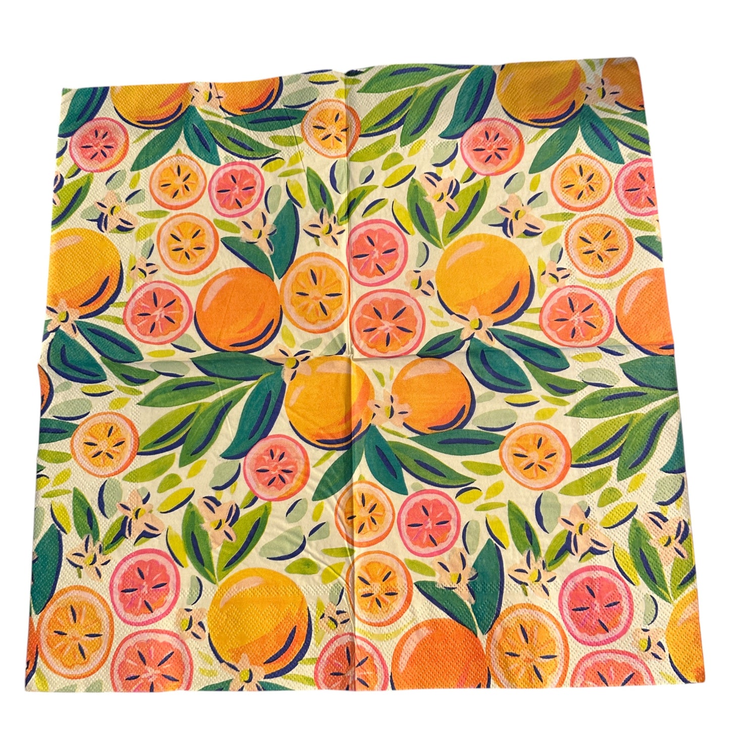 Close-up of an unfolded bright luncheon napkin featuring watercolor oranges, grapefruit, and green leaves designed by Kristen Vogel on a light cream background.