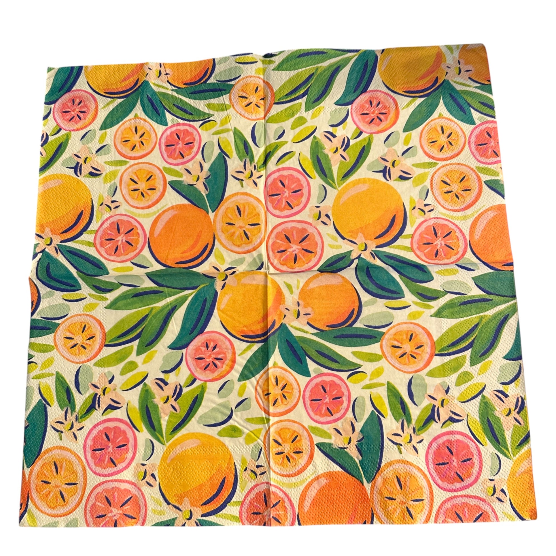 Close-up of an unfolded bright luncheon napkin featuring watercolor oranges, grapefruit, and green leaves designed by Kristen Vogel on a light cream background.